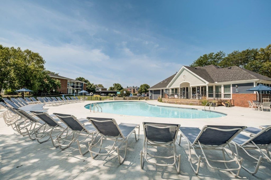 our apartments offer a pool with chairs around it