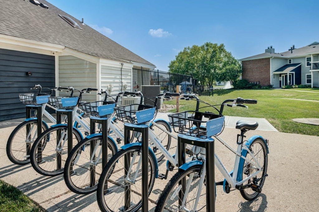 a row of blue bikes parked in front of a house
