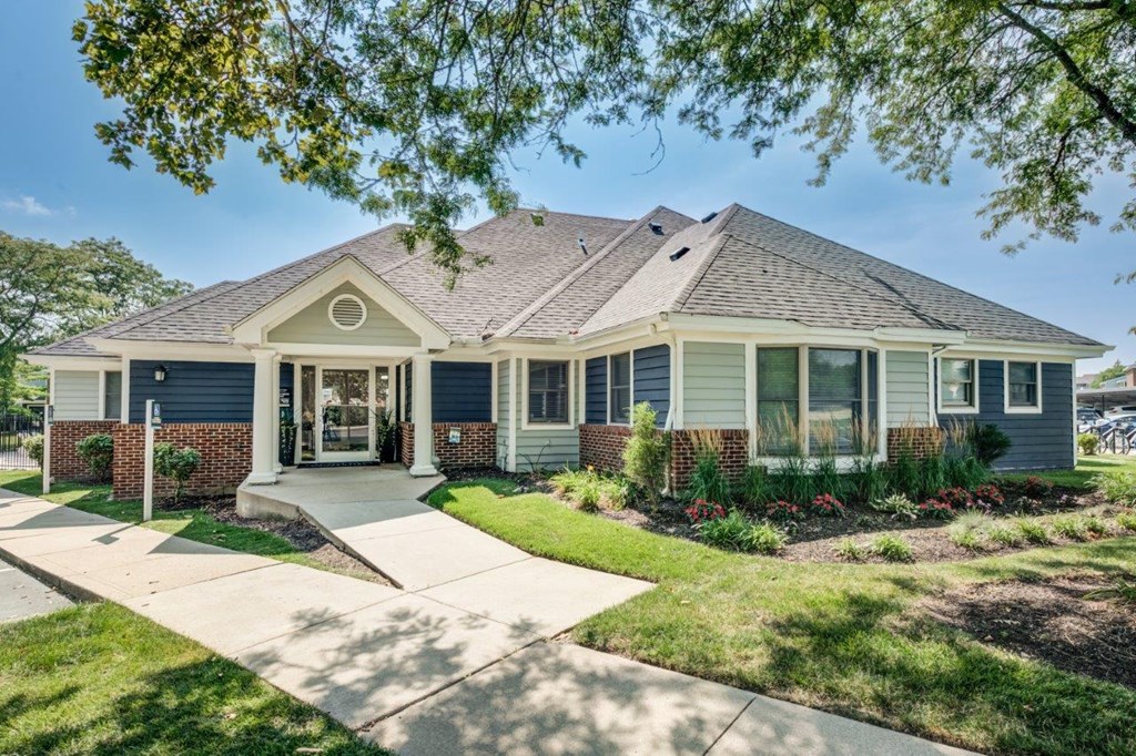 a blue house with a sidewalk in front of it