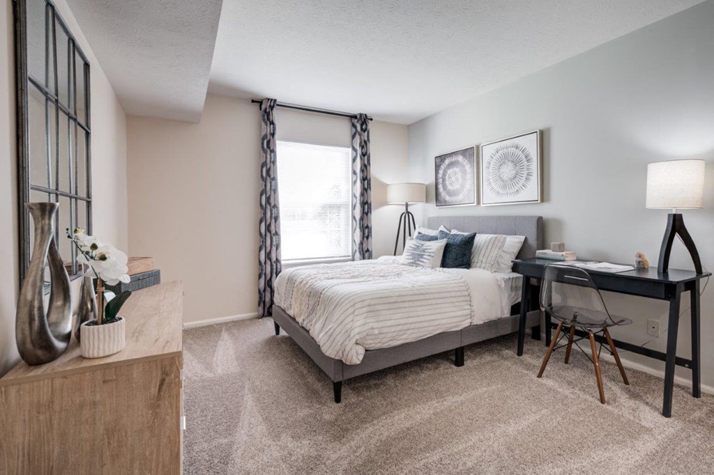 a bedroom with a bed and a desk