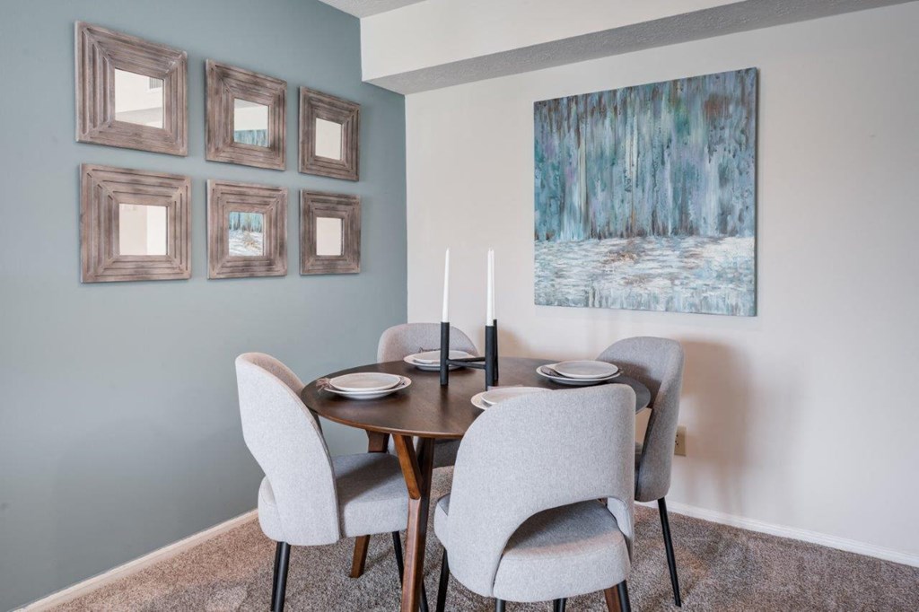 a dining room with a table and chairs