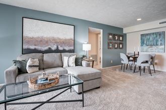 a living room and dining room with a couch and a table