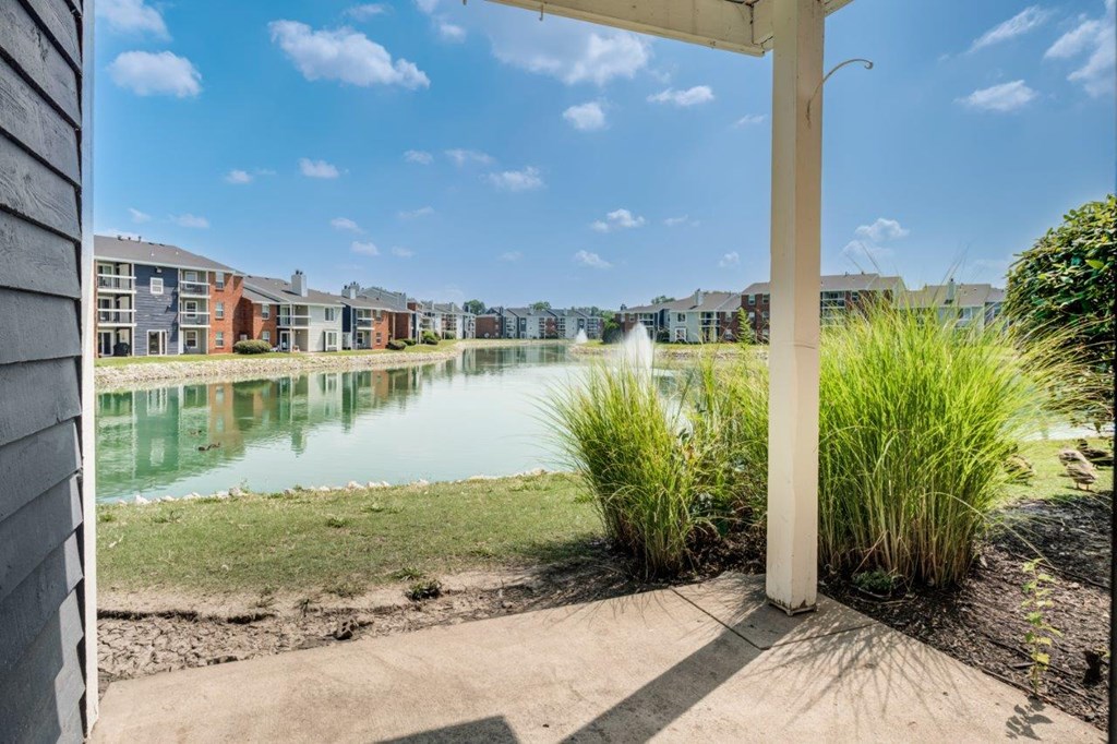 a view of a lake with apartments in the background