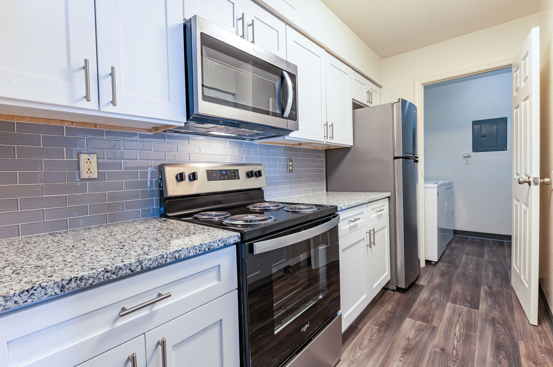 a kitchen with white cabinets and stainless steel appliances