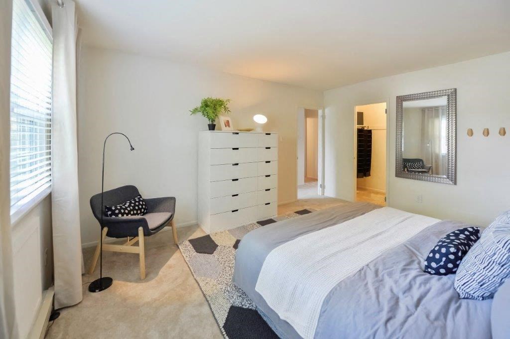 a bedroom with a bed and a dresser