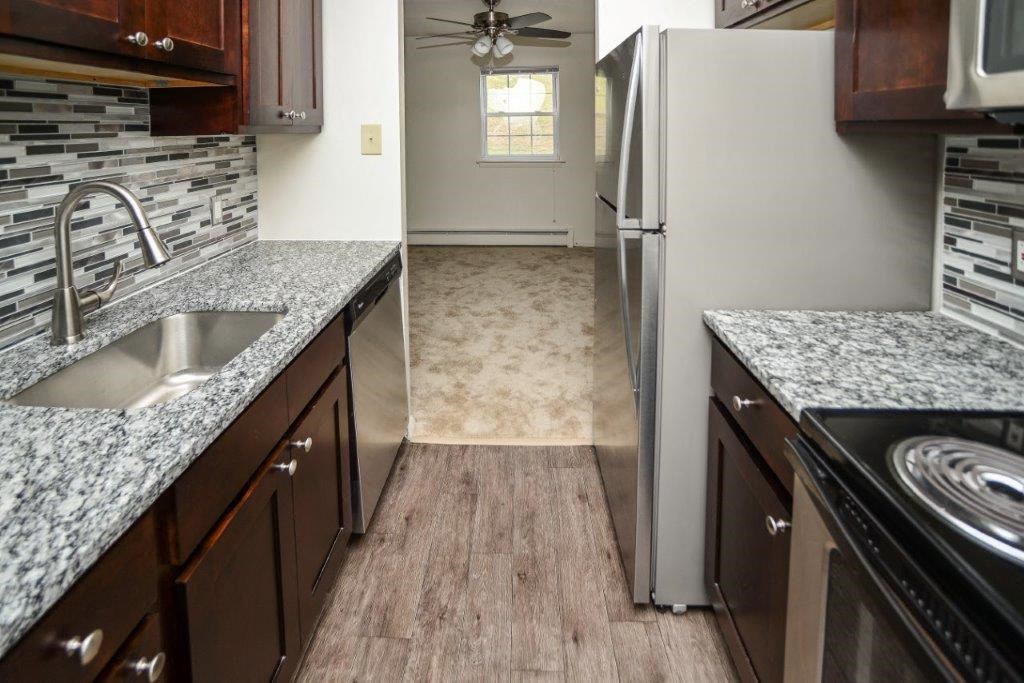 a kitchen with a sink and a refrigerator