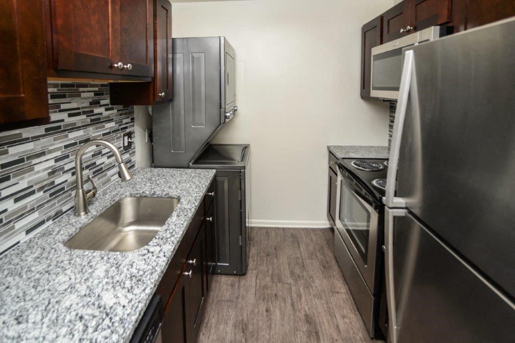 a kitchen with stainless steel appliances and granite counter tops