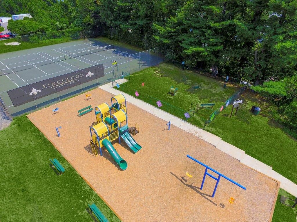 an aerial view of a playground and a tennis court