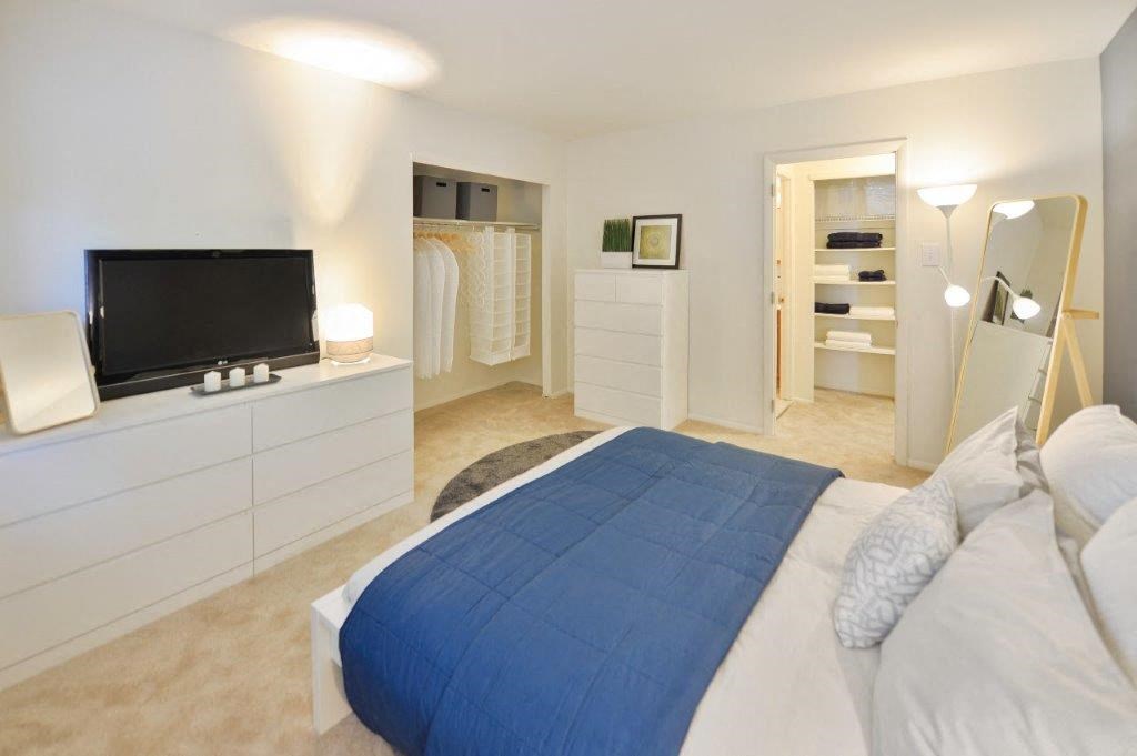 a bedroom with a bed and a television