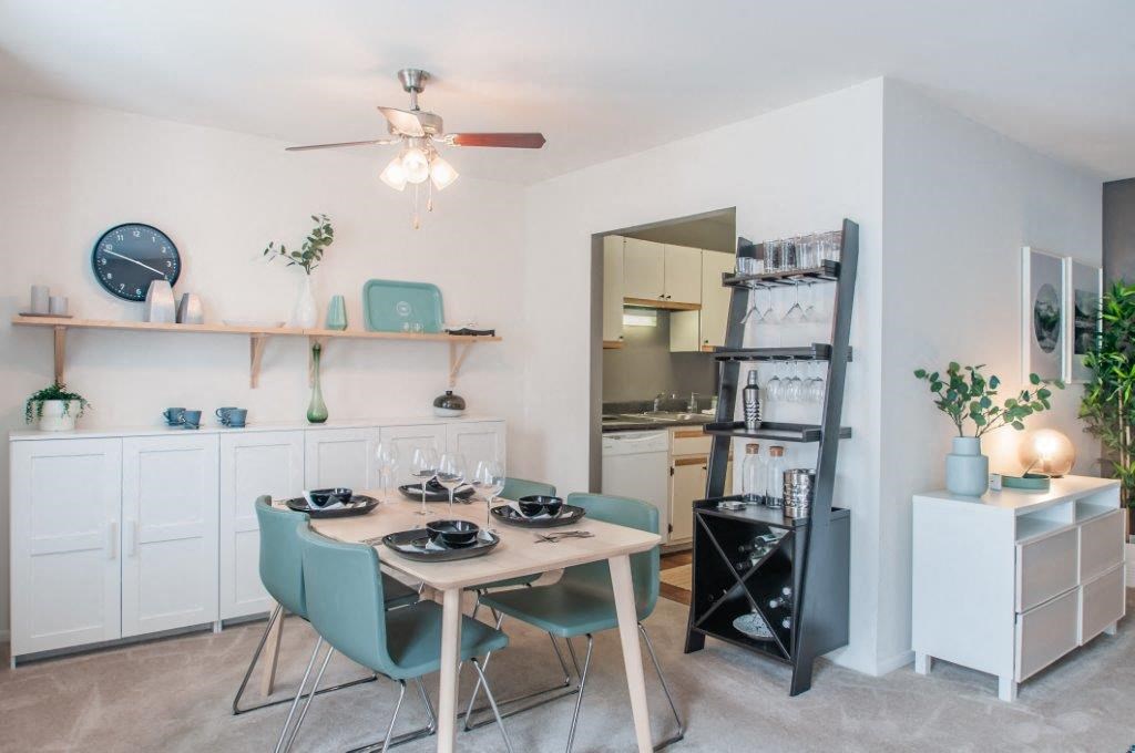 a dining room and kitchen with a table and chairs