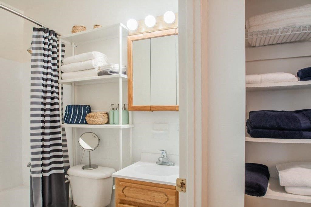 a bathroom with a shower curtain and a sink and a mirror