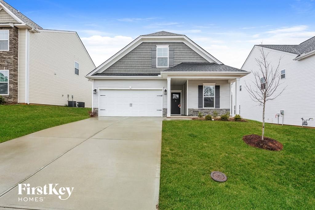 a white house with a sidewalk in front of it