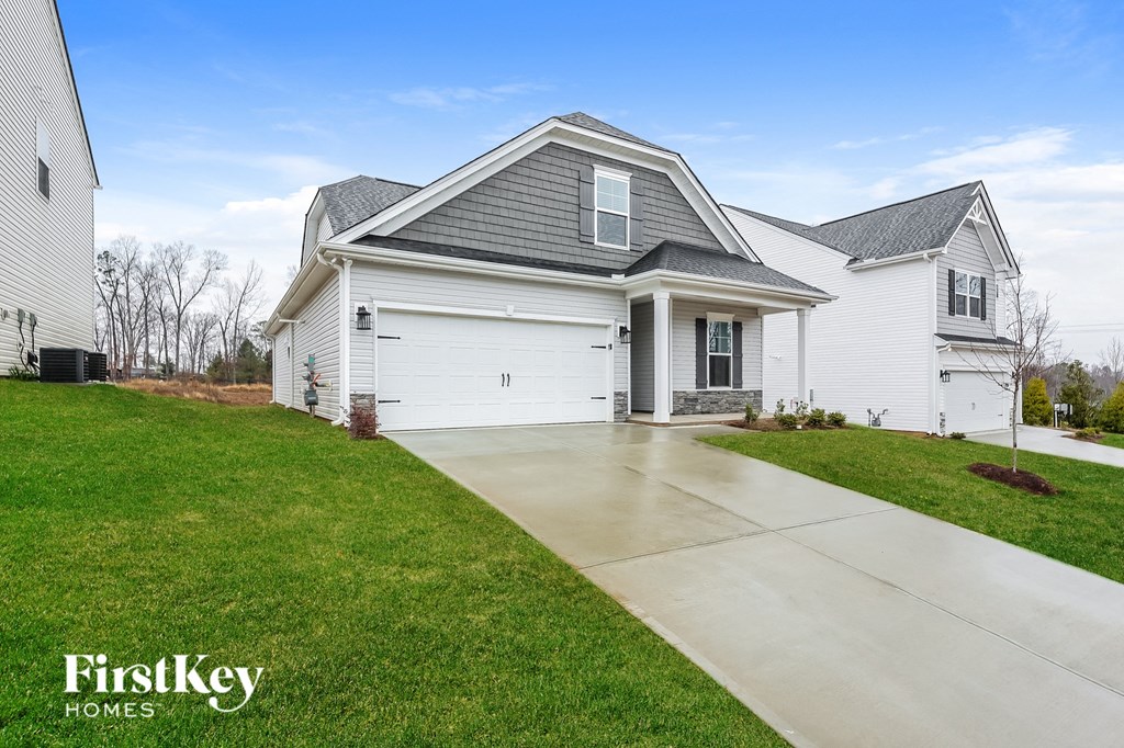 a white house with a sidewalk in front of it