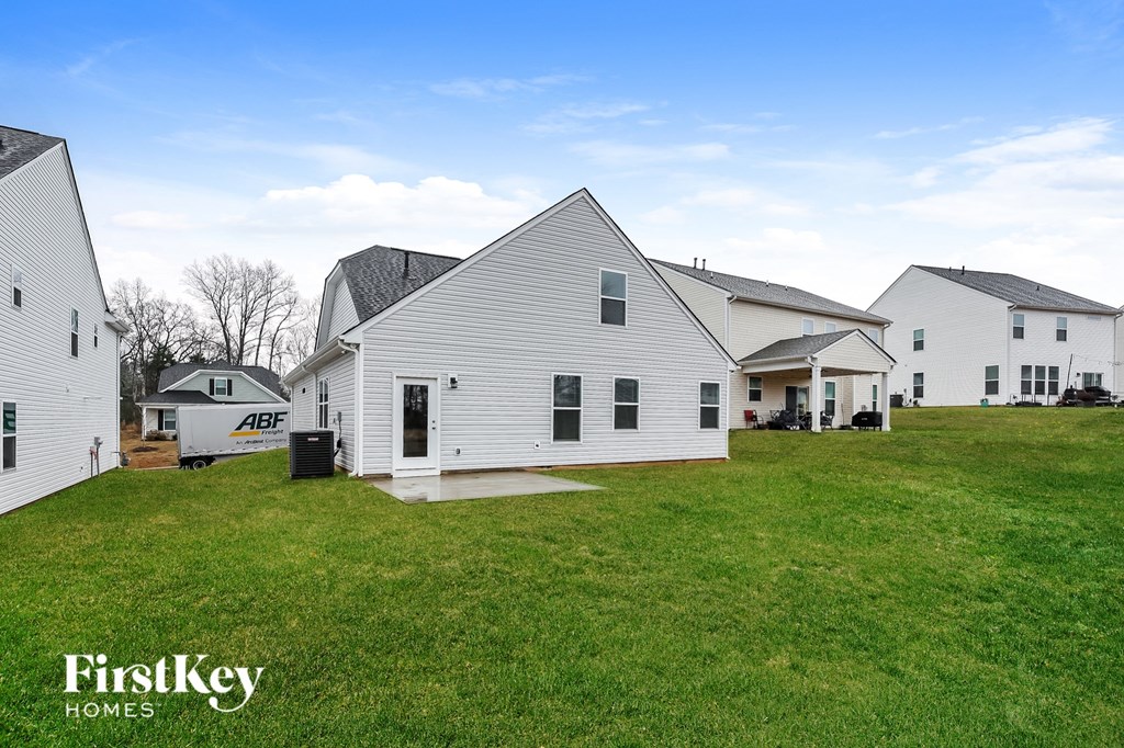 a white house with a yard in front of it