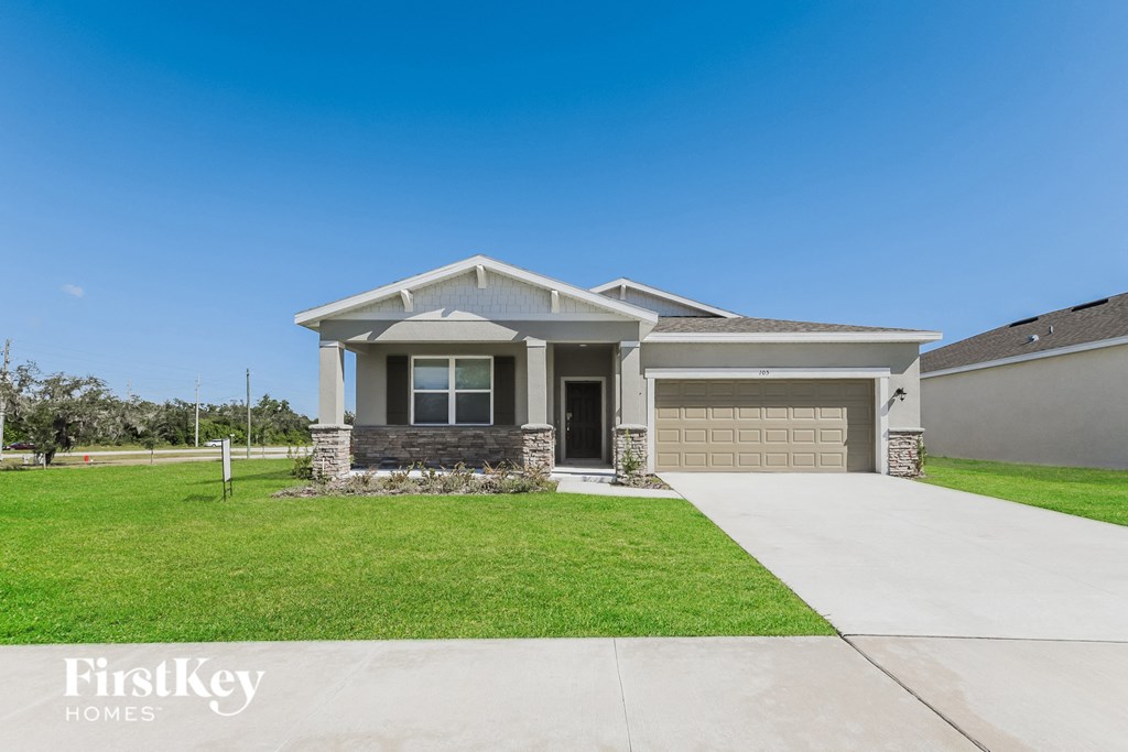a brand new house with a driveway and lawn