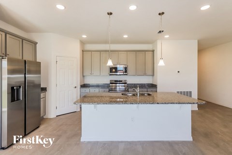 a kitchen with granite counter tops and stainless steel appliances
