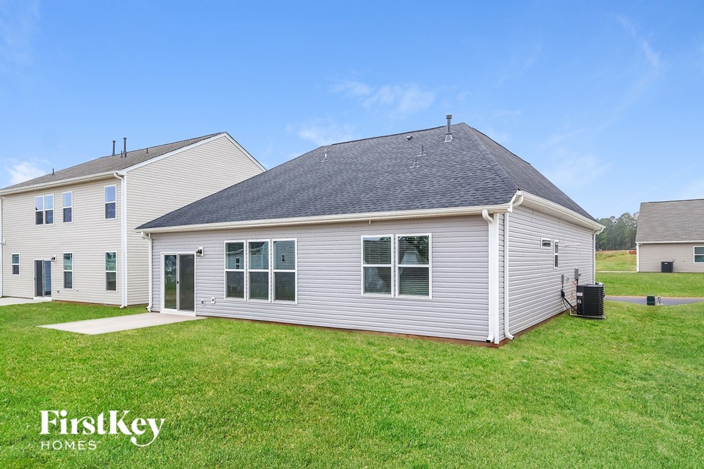 A house with a grey roof and a white exterior is shown with the words "FirstKey Homes" on the bottom left.
