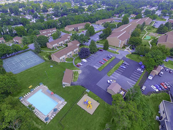 an aerial view of a neighborhood with a parking lot and a pool