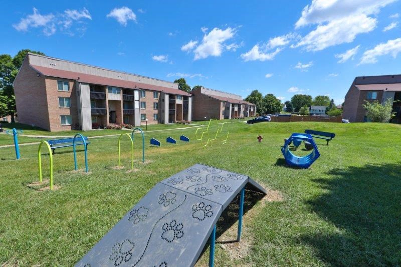 a park with a playground in front of a building