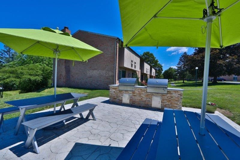 a picnic area with benches and umbrellas