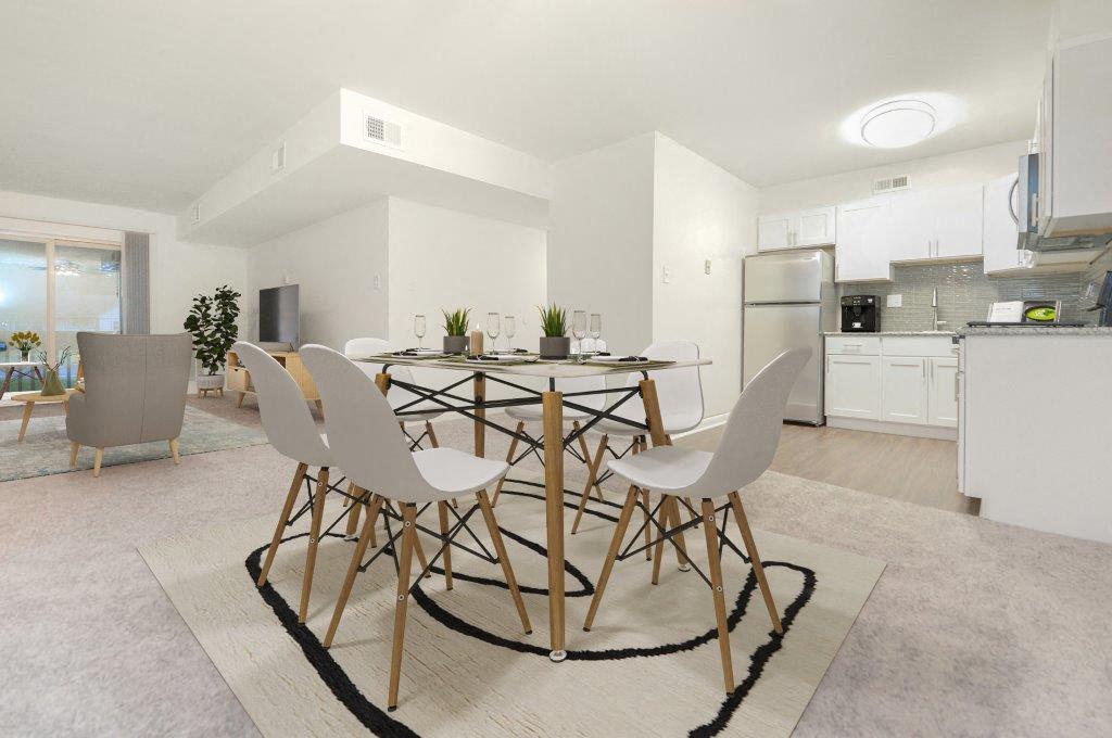 a kitchen and dining room with a table and chairs