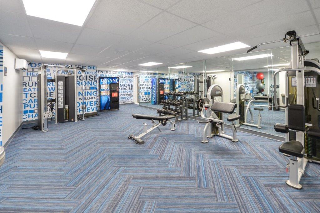 a gym with weights and other exercise equipment in a building