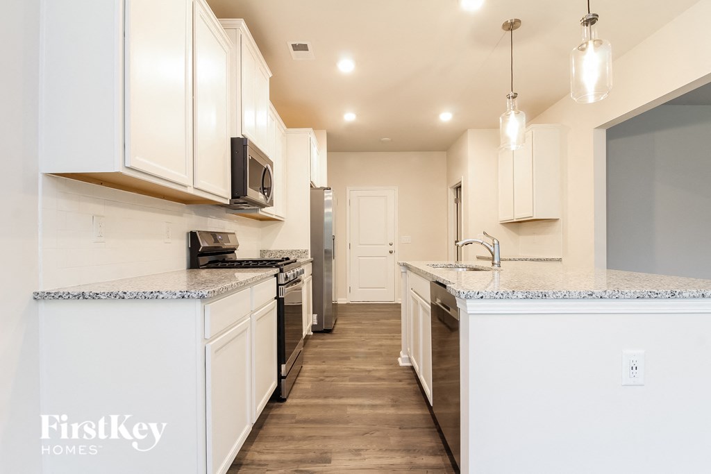 a kitchen with white cabinets and a counter top