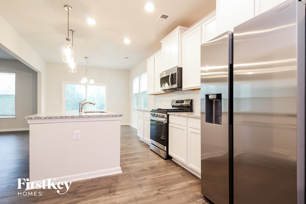 a kitchen with stainless steel appliances and white cabinets