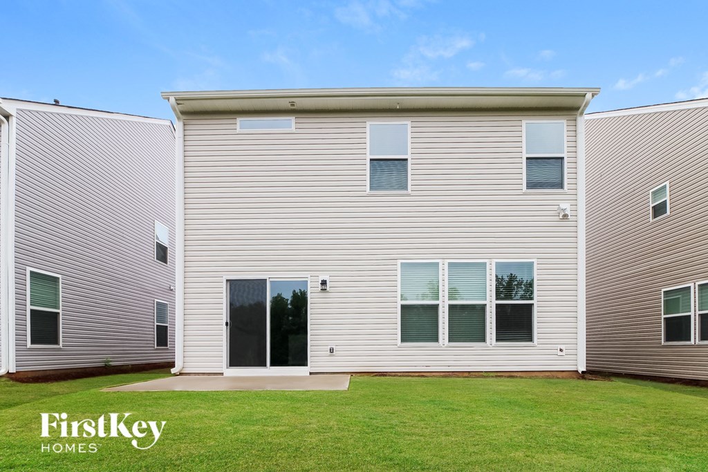 a white house with a lawn in front of it