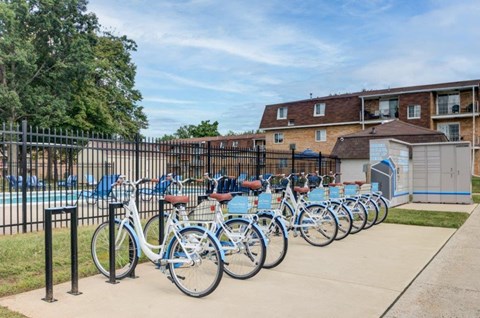 a row of bikes parked in front of a pool