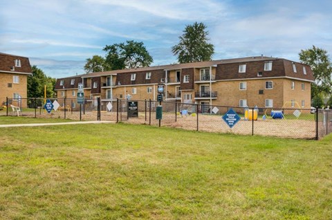a chain link fence in front of an apartment building