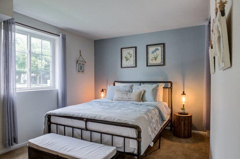 a bedroom with a bed and a window