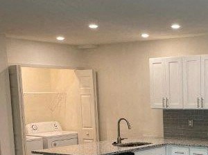a kitchen with stainless steel appliances and white cabinets