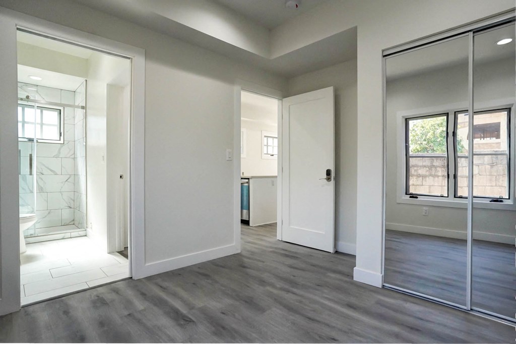 a living room with a mirror and a door to a bathroom