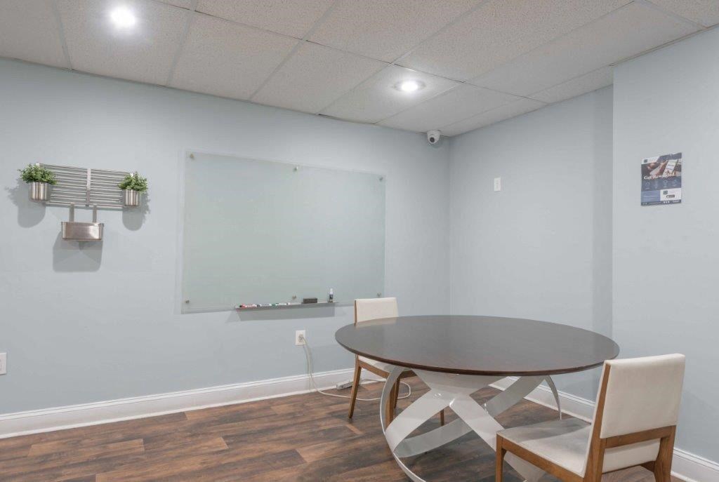 our conference room is equipped with a table and chairs and a projection screen