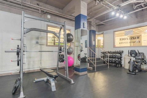 a gym with weights and other equipment in a building