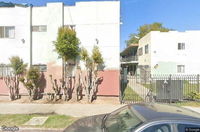 a car parked in front of an apartment building