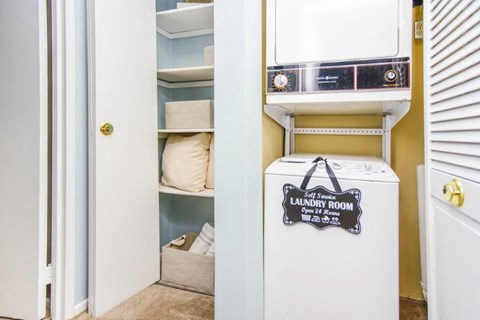 a laundry room with a washer and dryer and a closet