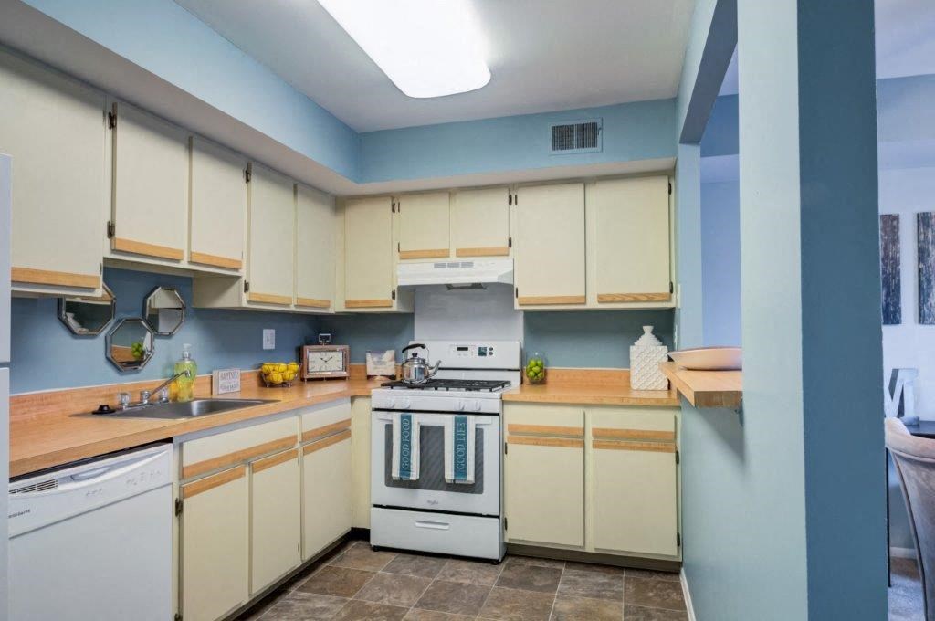 a kitchen with white appliances and white cabinets
