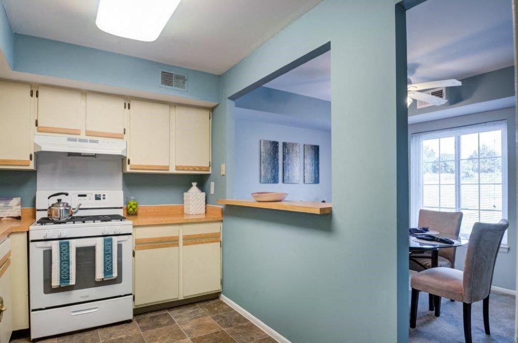 a kitchen and dining room with a stove and a window