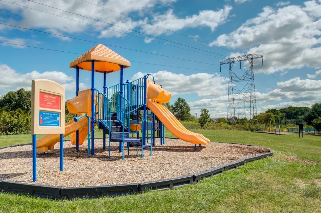 a playground with a blue and yellow swing set