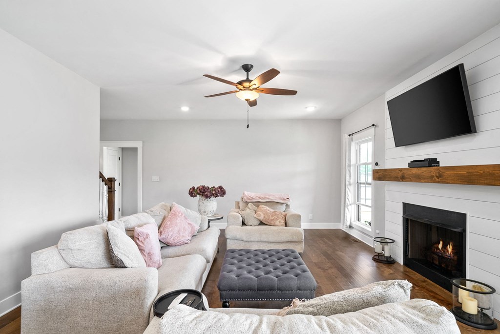 a living room with a couch and a tv and a fireplace
