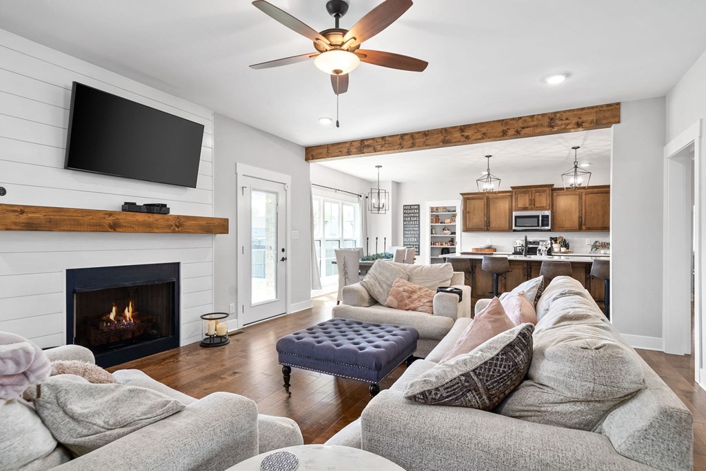 a living room with couches and a tv and a fireplace