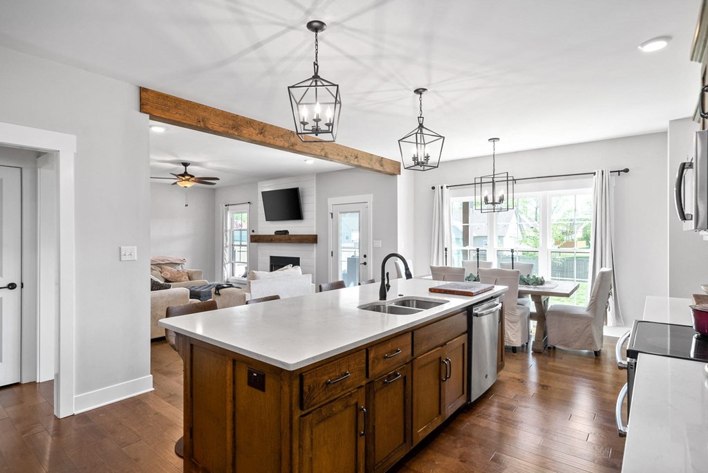 a kitchen with an island and a living room with a couch and a tv