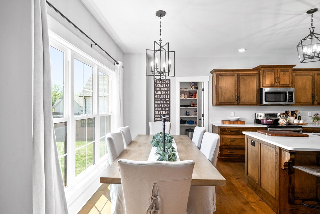 a kitchen with a table and chairs and a large window