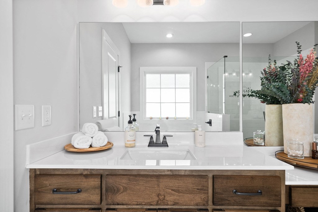 a white bathroom with a sink and a mirror