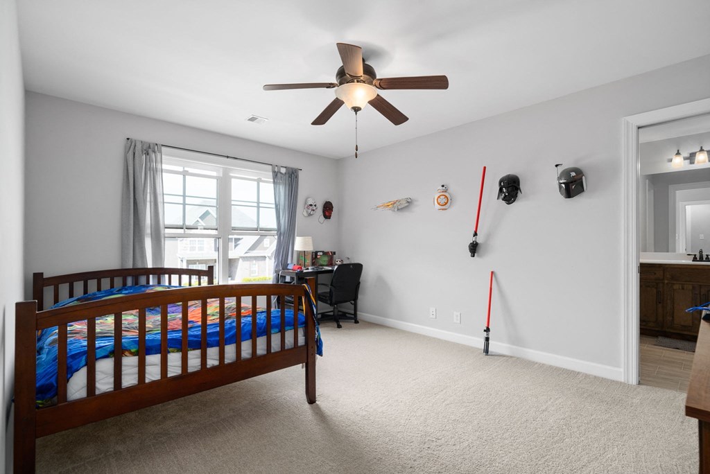 a bedroom with a bed and a ceiling fan