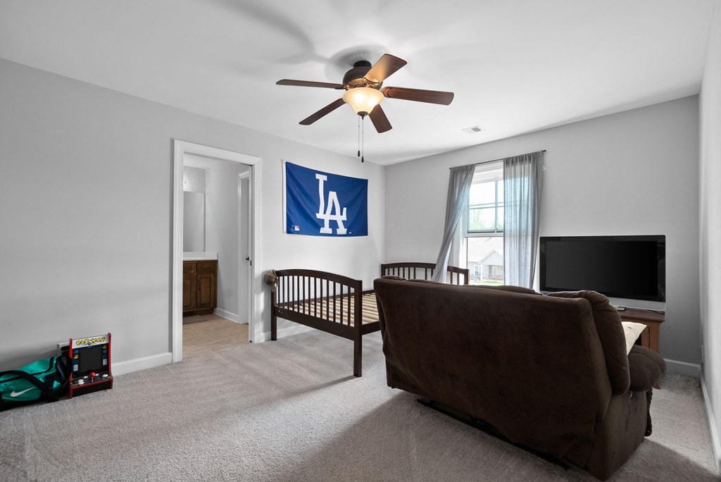 a living room with a couch and a ceiling fan