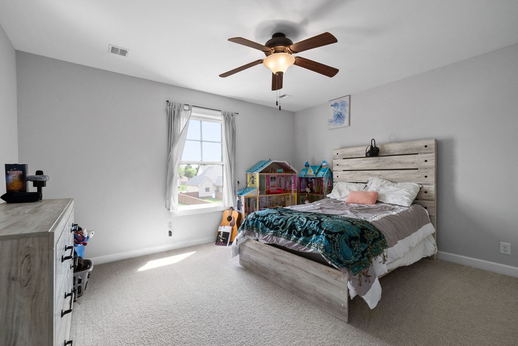 a bedroom with a bed and a ceiling fan