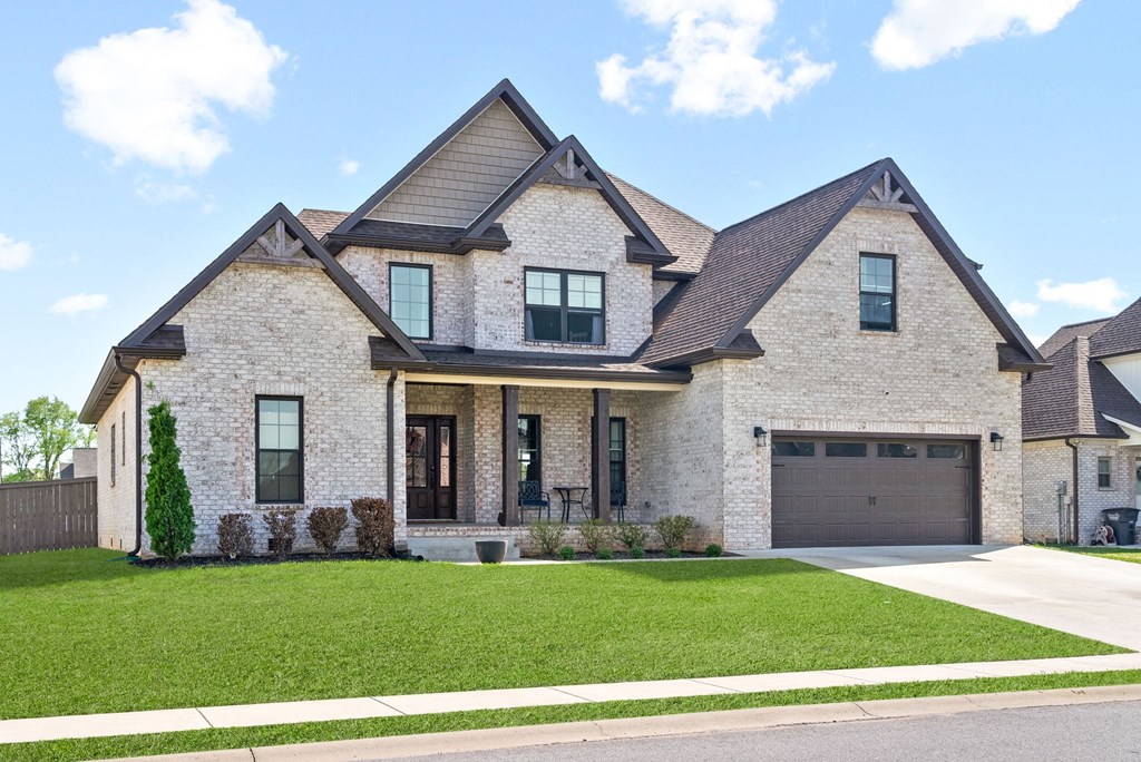 a large brick house with a lawn in front of it